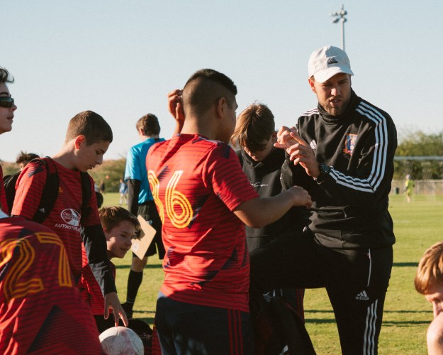 Coach encouraging his team to self-reflect