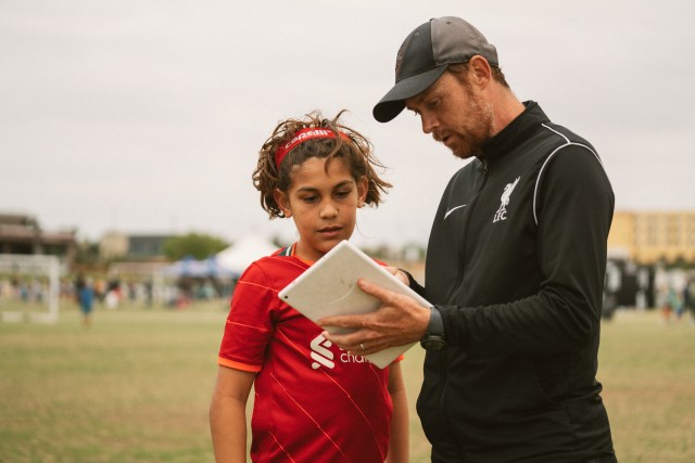 coach showing recording of soccer game