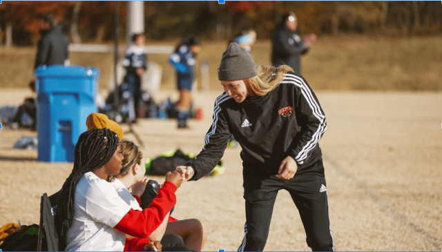 Coach giving positive feedback and encouragement Coach giving positive feedback and encouragement